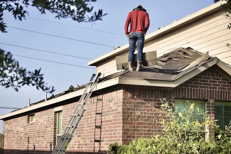 Professional roofer working on a residential roof in Yolo
